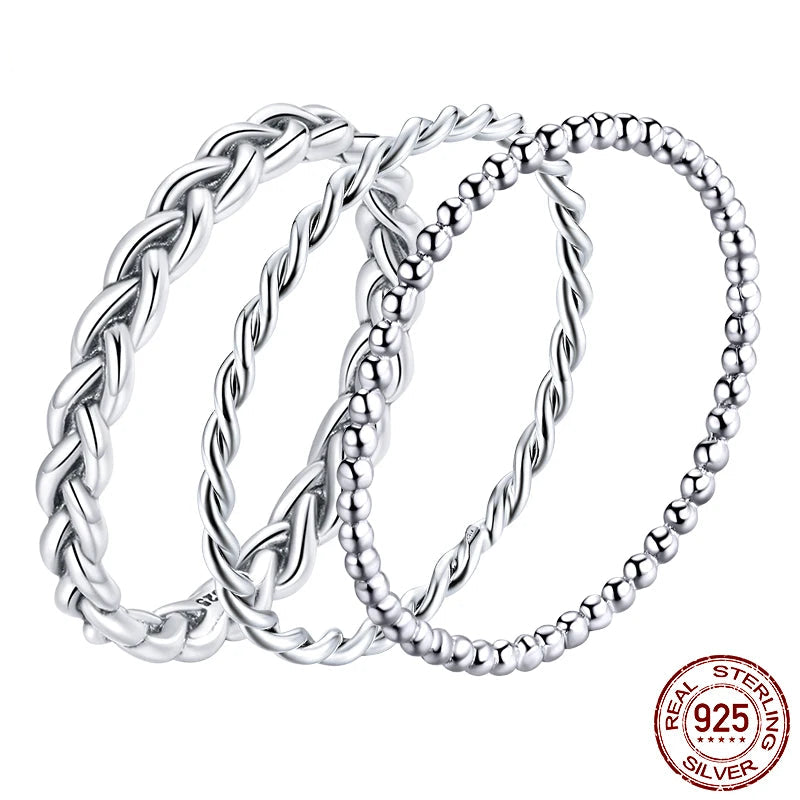 Set of braided, twisted, and beaded 925 sterling silver stacking rings on a white background — OmniVivo