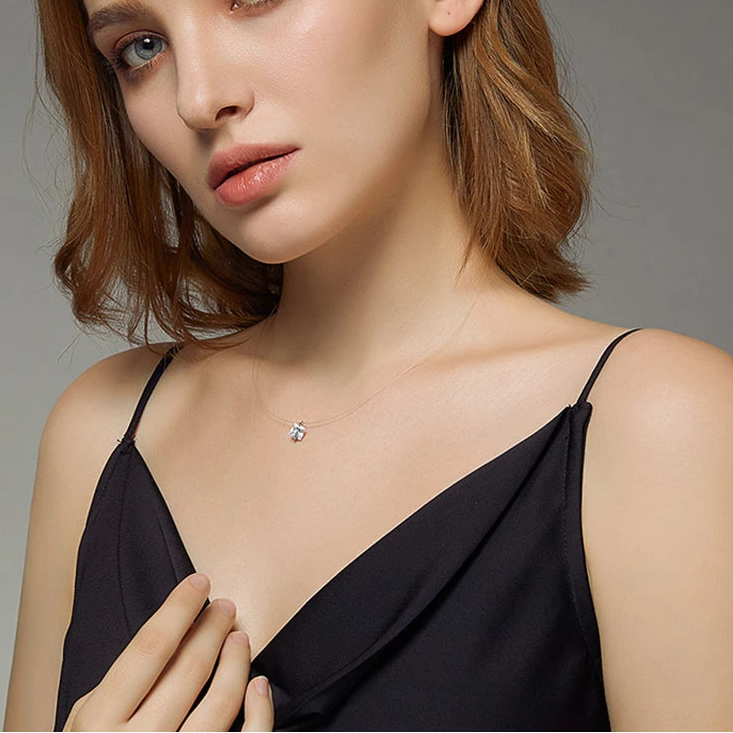 Model wearing invisible chain necklace with round zircon pendant in 925 sterling silver, floating effect on neutral background — OmniVivo