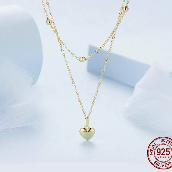 14K gold plated double-layer 925 sterling silver heart pendant necklace with beaded station and link chains on a light background — OmniVivo