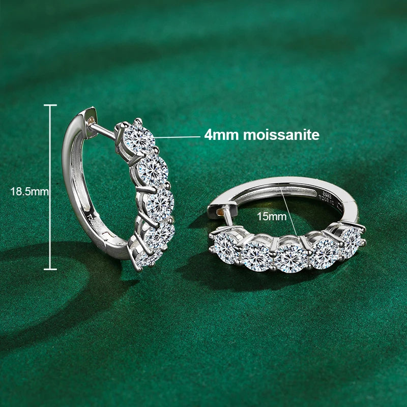 925 sterling silver hoop earrings in white gold tone (rhodium finish), set with 4 mm round-cut moissanite; technical diagram showing 18.5 mm height and 15 mm inner diameter on green background — OmniVivo