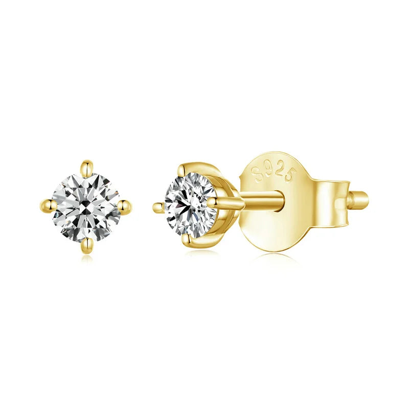 A pair of sparkling Nayla Moissanite 4-prong stud earrings in a luxurious gold tone, showcasing their dazzling D Color VVS1 Hearts & Arrows Moissanite stones and secure post backs.