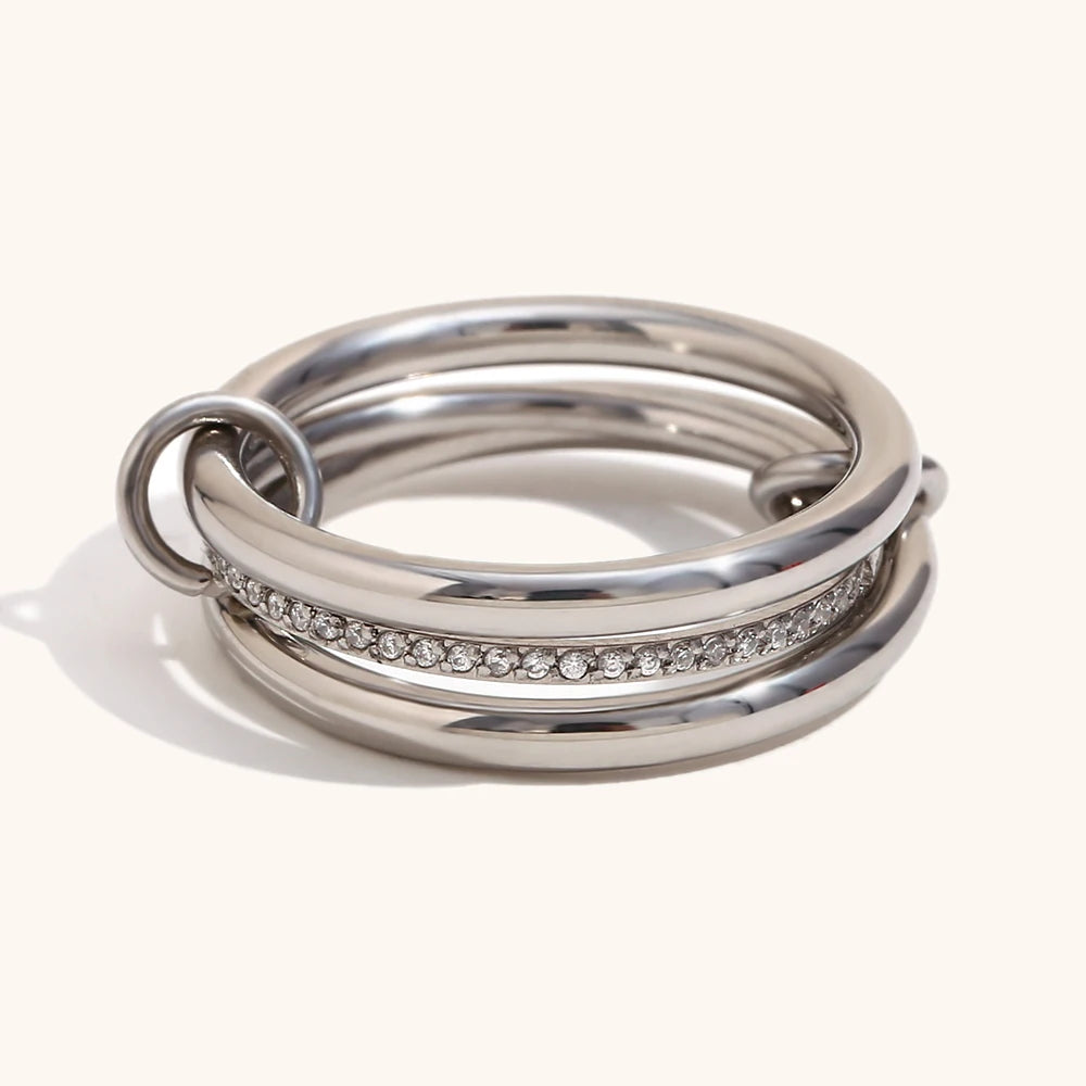 A sleek NeoVox multi-layer statement ring in silver tone, featuring a bold geometric stack design with a central band of sparkling cubic zirconia, ideal for a contemporary and edgy look.