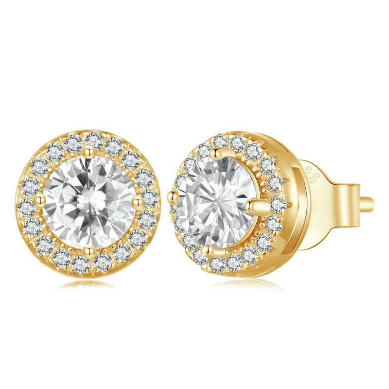A sparkling pair of Serena Halo CZ Stud Earrings in a luxurious gold tone, featuring a brilliant round central cubic zirconia stone encircled by a micro-pavé halo, showcasing their celestial elegance and radiant design.