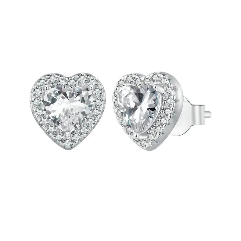A sparkling pair of Serena Halo CZ Stud Earrings in 925 sterling silver, featuring a brilliant heart-shaped central cubic zirconia stone encircled by a micro-pavé halo, showcasing their romantic and elegant design.