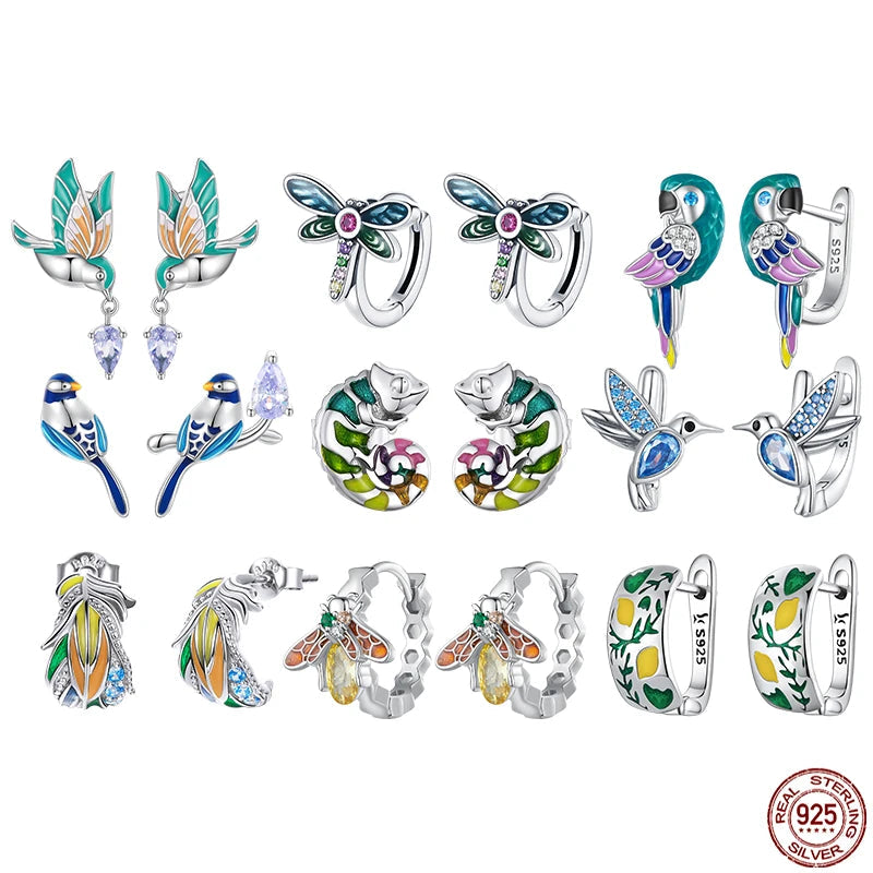A vibrant collection of sterling silver nature-inspired earrings, featuring various bird designs like hummingbirds and parrots, and intricate insect motifs such as dragonflies and bees. Each piece is adorned with colorful enamel and sparkling cubic zirconia, showcasing diverse styles.