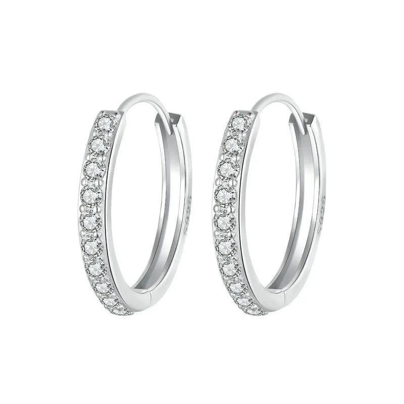 Pair of 925 sterling silver huggie hoop earrings with pavé round cubic zirconia, polished finish, on a white background – OmniVivo.