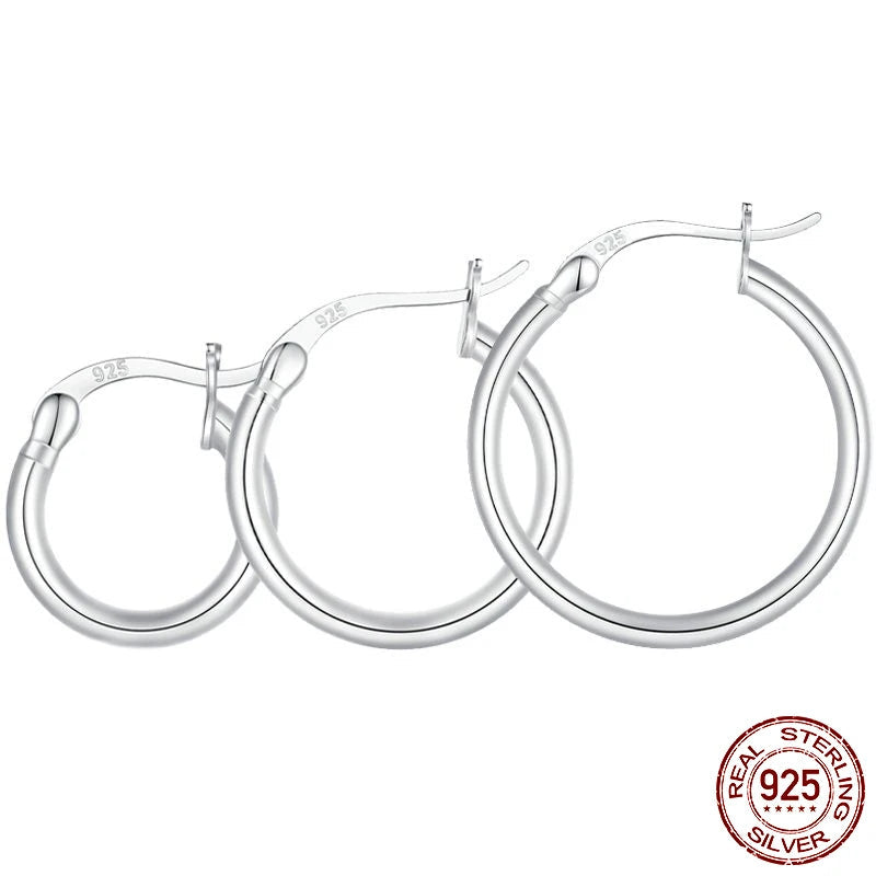 Glossy tube 925 sterling silver hoop earrings (24×2 mm, 21 mm inner diameter), 14K white gold plated with snap bar closure on a white background — OmniVivo