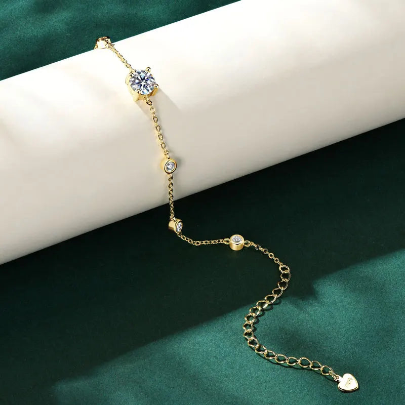 Gold-tone 925 sterling silver moissanite bracelet with 6.5 mm center and 2.5 mm accents, adjustable extender and heart tag — OmniVivo