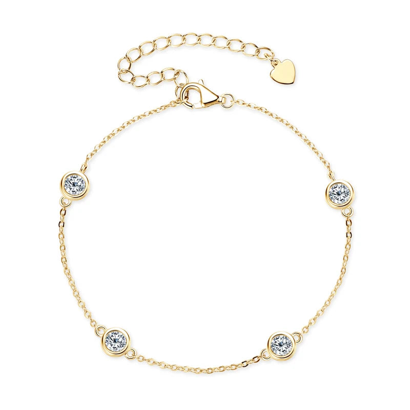 Gold-tone 925 sterling silver moissanite station bracelet with 2.5 mm bezel-set stones, adjustable extender chain and heart tag on a white background — OmniVivo
