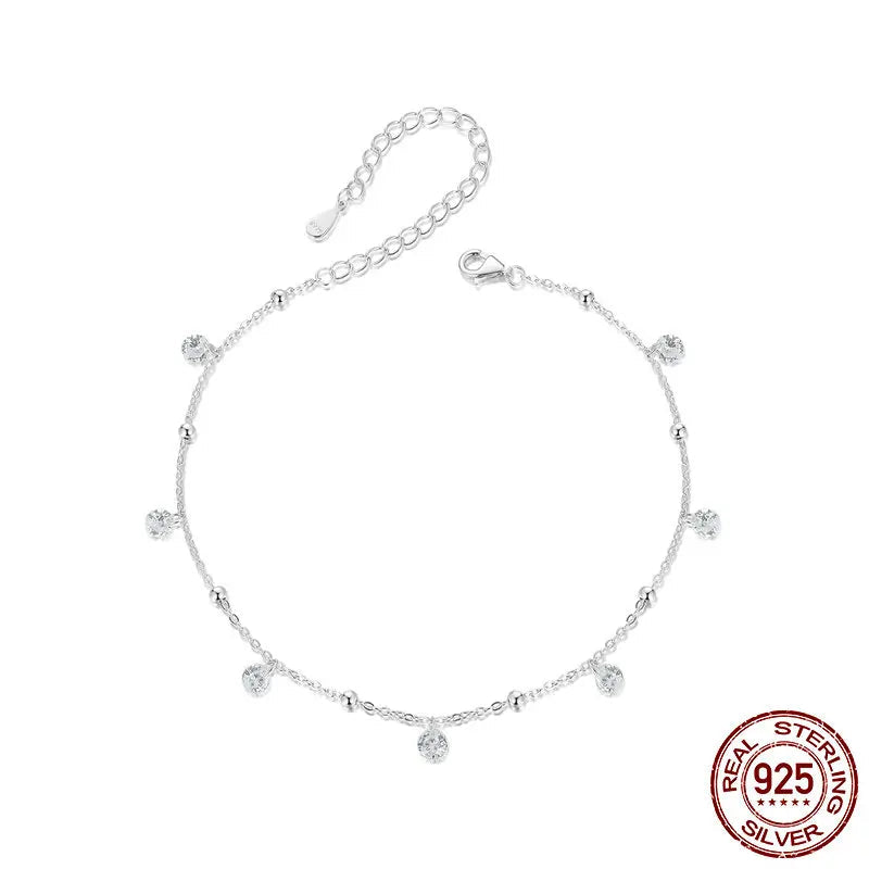 925 sterling silver cubic zirconia anklet with adjustable extender and dangle charms — flatlay on white background.