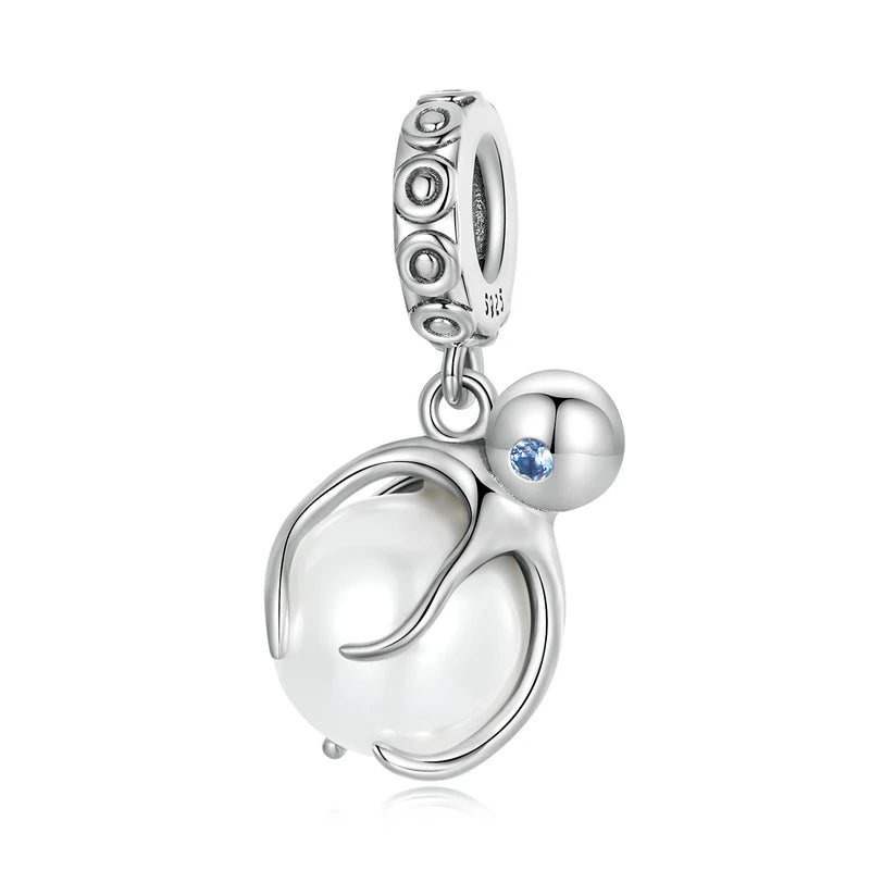 925 sterling silver penguin charm bead hugging a round pearl with a blue zircon accent on a white background.
