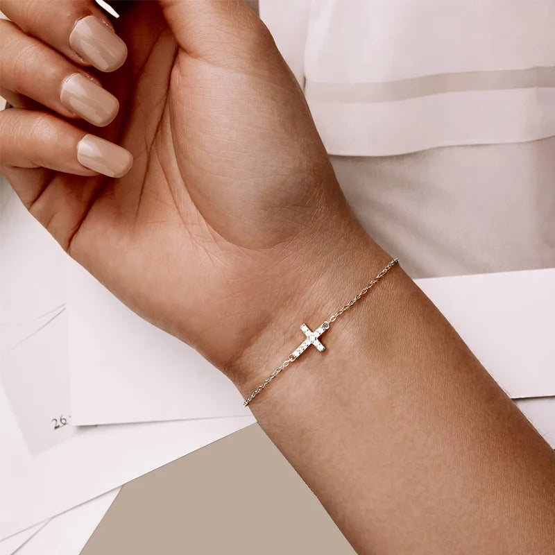 Adjustable 14K gold plated 925 sterling silver cross bracelet with zircon charm on link chain, stamped S925, on a white background — OmniVivo