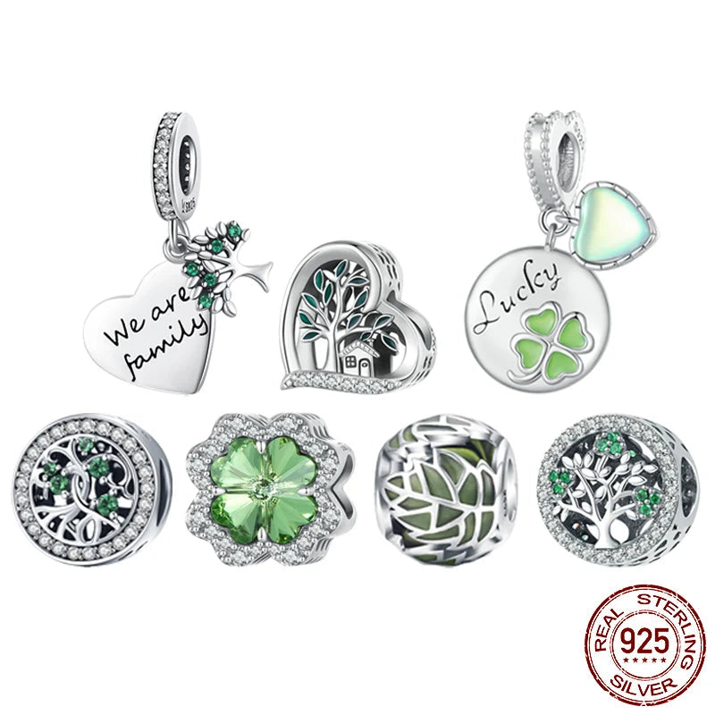 Collection of 925 sterling silver charms with green accents, clover and Tree of Life designs, on white background — OmniVivo