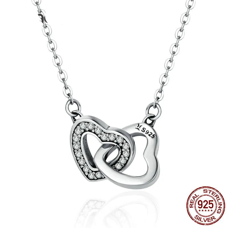 925 sterling silver connected heart pendant necklace with zircon stones, polished link chain, minimalist romantic style on white background — OmniVivo