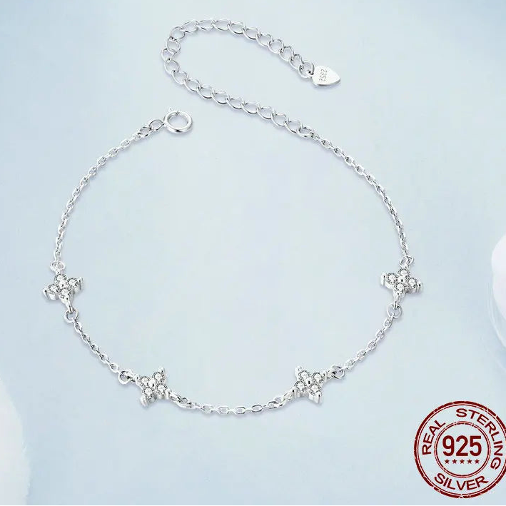 925 sterling silver floral anklet with delicate chain and adjustable extender, full product view displayed on a light blue background with polished finish and visible 925 stamp — OmniVivo
