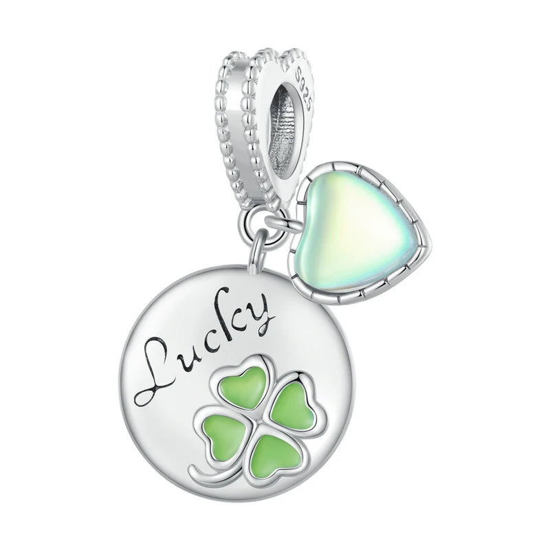 925 sterling silver Lucky clover charm featuring green enamel accents and engraved lettering, clean product shot on white background — OmniVivo
