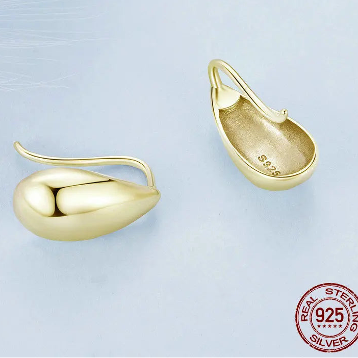 Gold tone teardrop earrings crafted in 925 sterling silver, close-up detail showing the 925 stamp on the back, polished minimalist finish on a light blue background — OmniVivo
