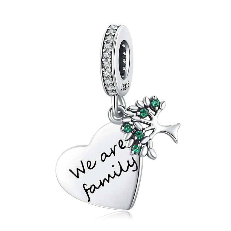 925 sterling silver heart tag charm engraved with “We are family”, featuring green leaf accents, clean product shot on white background — OmniVivo
