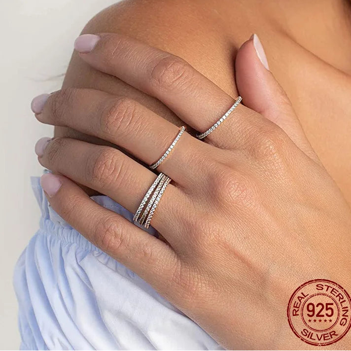925 sterling silver micro pavé eternity ring with 1.5mm CZ stones, slim stackable band worn on hand, polished finish, hypoallergenic — OmniVivo