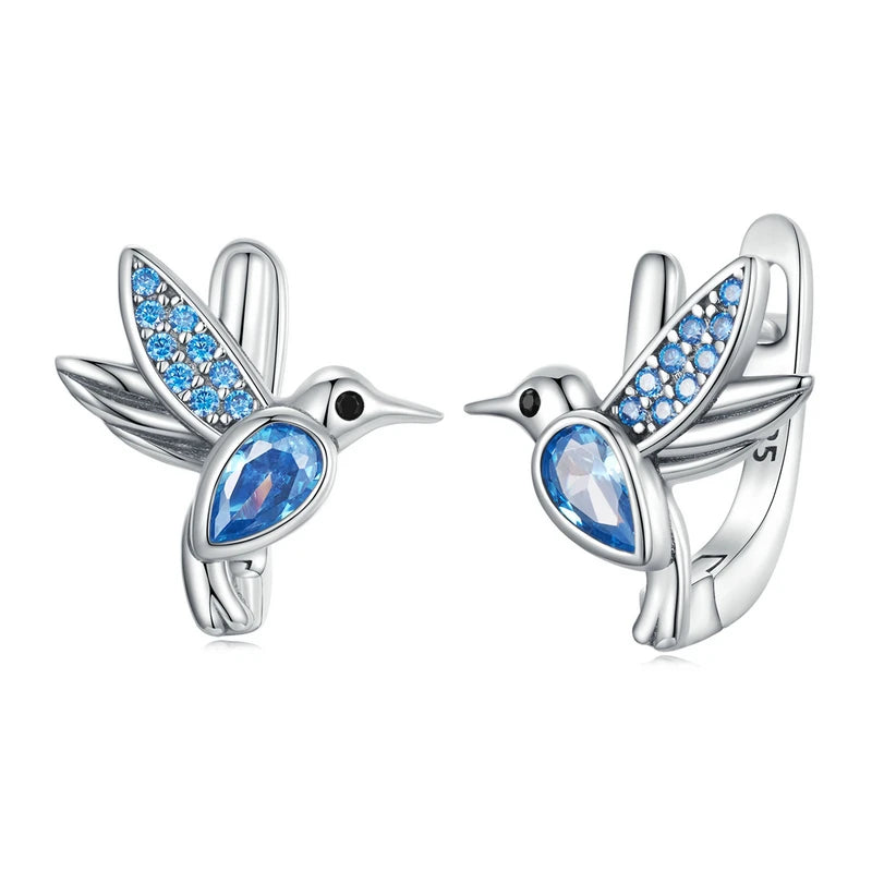 Bird huggie earrings crafted in 925 sterling silver with blue gemstone accents and pavé wing details, elegant nature-inspired design on white background — OmniVivo