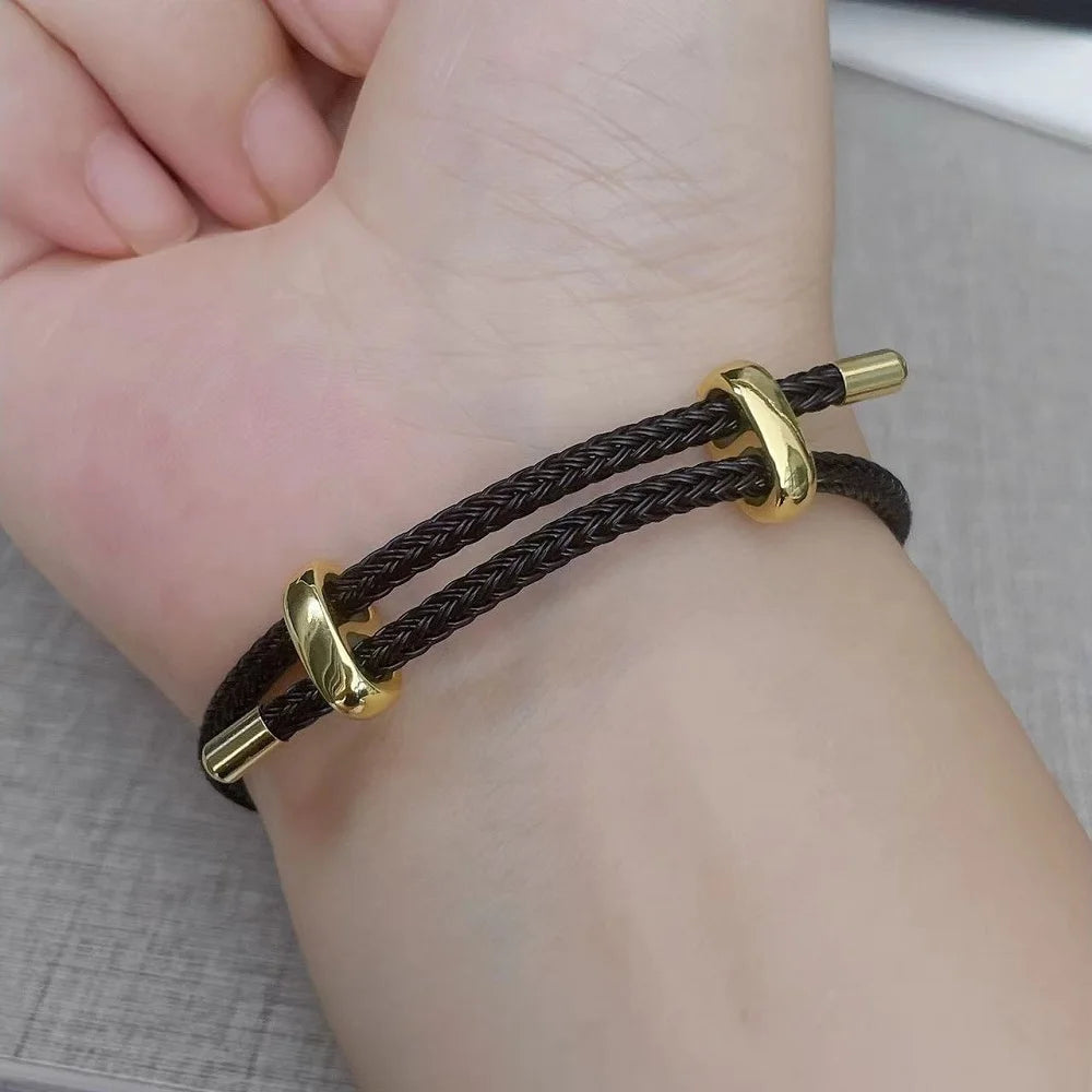 Brown braided rope bracelet with polished gold bar clasp, double-wrap unisex design shown on wrist, lightweight and stackable, lifestyle close-up — OmniVivo