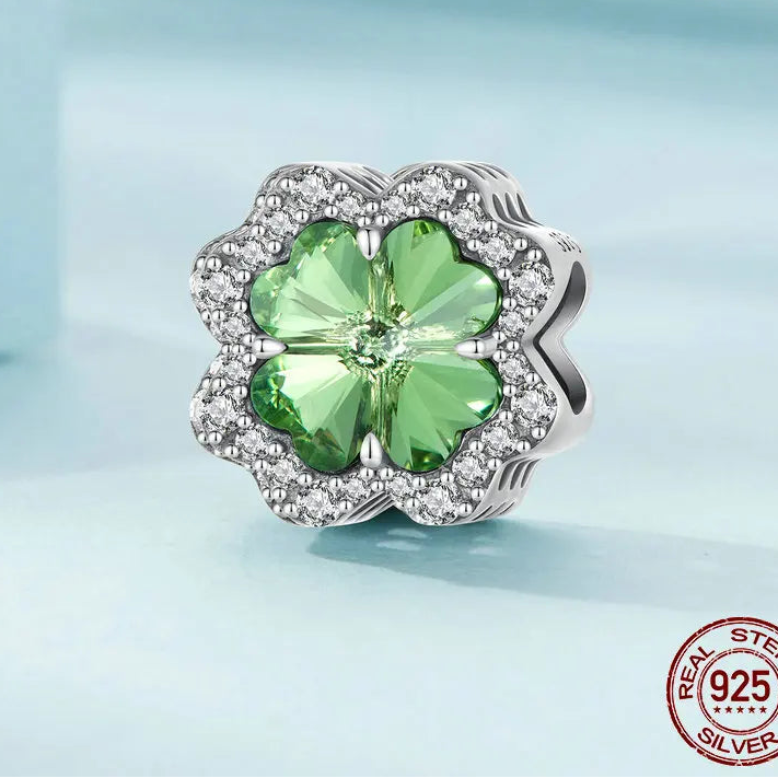 Close-up of Clover Tree of Life charm crafted in 925 sterling silver, featuring a faceted green zircon center on light blue background — OmniVivo
