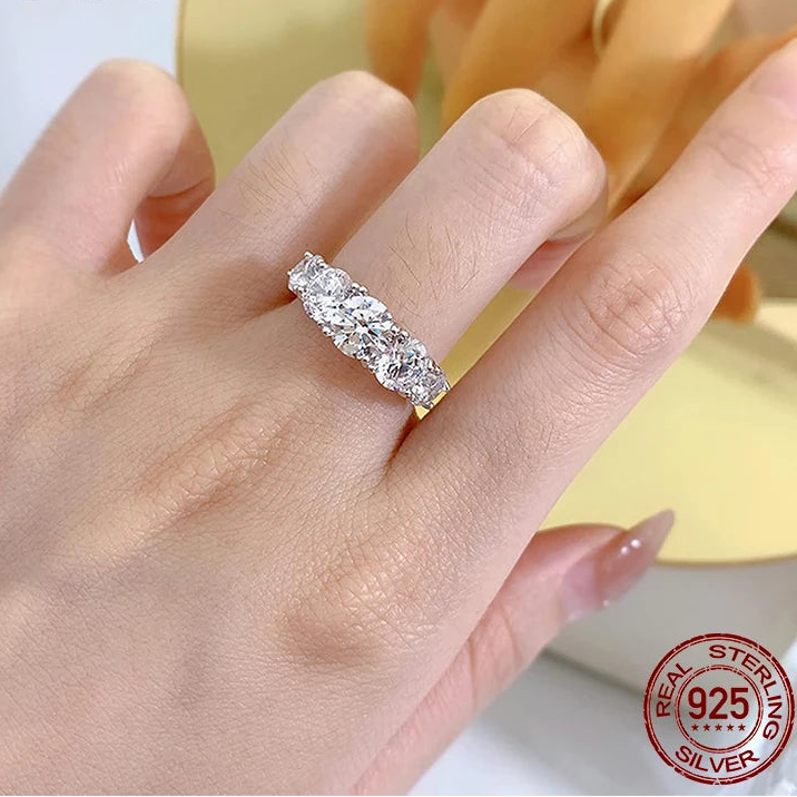 0.5ct D color moissanite multi-stone 925 sterling silver ring shown on hand in natural light, elegant prong setting — OmniVivo
