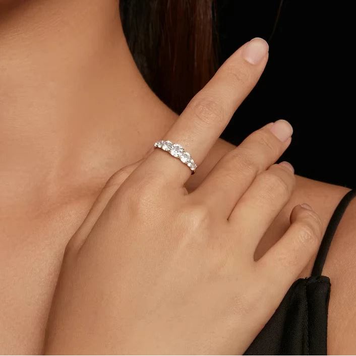 0.5ct D color moissanite multi-stone 925 sterling silver ring shown on a model’s hand against a black background, elegant style — OmniVivo
