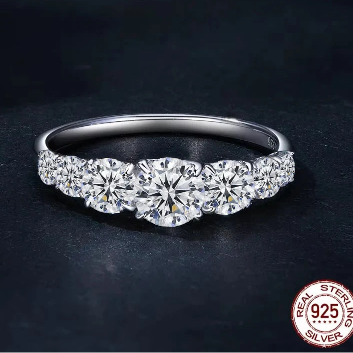 0.5ct D color moissanite 925 sterling silver three-stone ring showcased on a dark background with premium shine — OmniVivo
