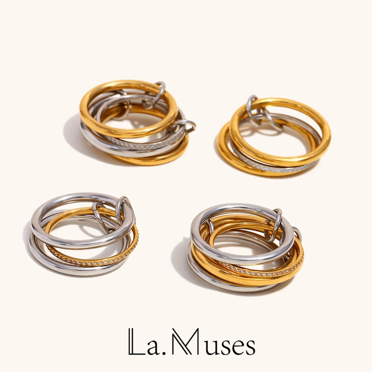 A collection of four NeoVox multi-layer statement rings, showcasing mixed metal designs with both polished gold and silver tones, some featuring sparkling zircon accents, presented as a versatile and stackable set.
