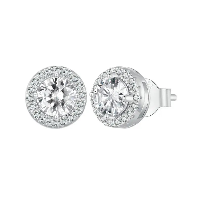 A sparkling pair of Serena Halo CZ Stud Earrings in 925 sterling silver, featuring a brilliant round central cubic zirconia stone encircled by a micro-pavé halo, showcasing their celestial elegance and radiant design.