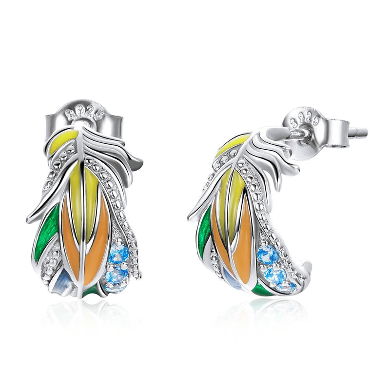 A vibrant pair of sterling silver feather-shaped earrings, featuring a colorful enamel design in green, yellow, and orange, accented with sparkling blue cubic zirconia, perfect for a whimsical and eye-catching look.