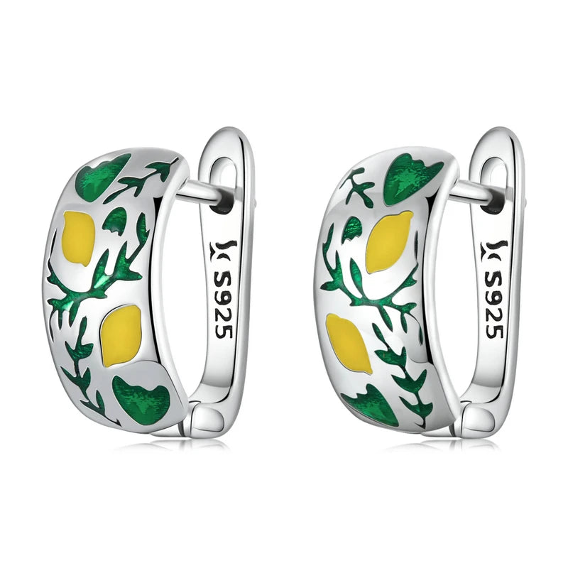 A playful pair of sterling silver hoop earrings, featuring a vibrant enamel design of yellow lemons and green leaves, perfect for adding a fresh and unique touch to any outfit.