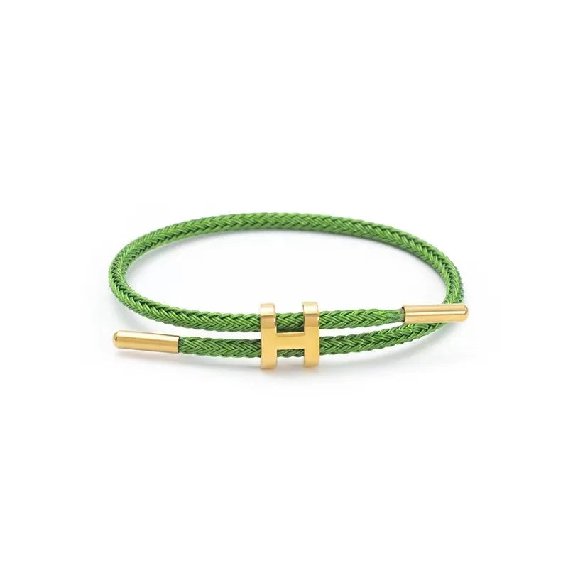 Green braided rope bracelet with gold-tone stainless steel clasp, adjustable unisex casual bracelet on white background — OmniVivo
