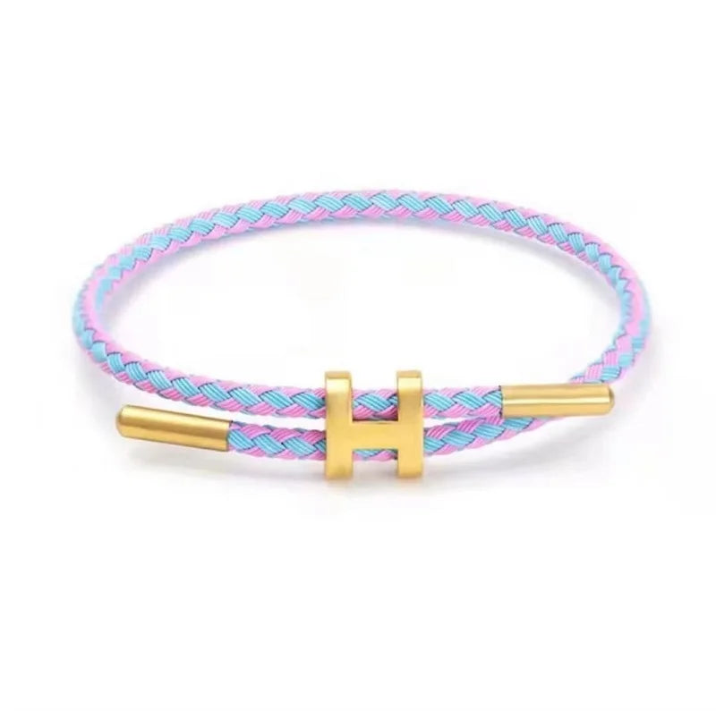 Pink and blue braided rope bracelet with gold-tone stainless steel clasp, adjustable unisex casual bracelet on white background — OmniVivo
