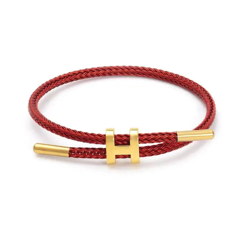 Red braided rope bracelet with gold-tone stainless steel clasp, adjustable unisex casual bracelet on white background — OmniVivo
