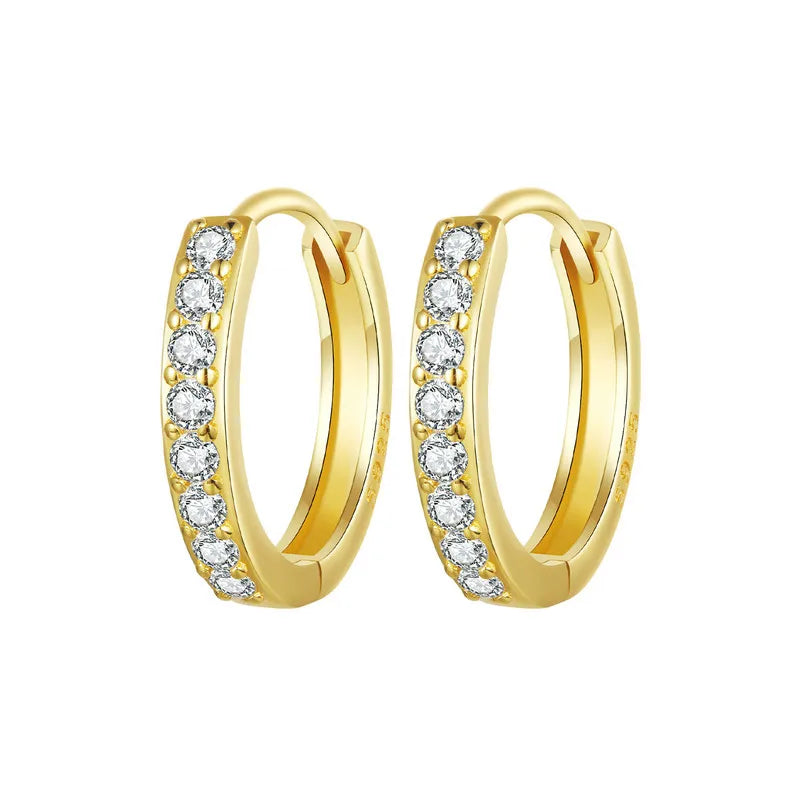 Pair of gold-plated 925 sterling silver huggie hoop earrings with pavé round cubic zirconia on a white background – OmniVivo.