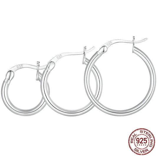 Glossy tube 925 sterling silver hoop earrings (24×2 mm, 21 mm inner diameter), 14K white gold plated with snap bar closure on a white background — OmniVivo