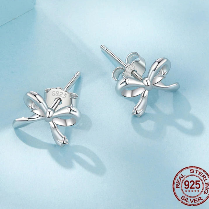 925 sterling silver bow stud earrings on ear – minimalist ribbon design