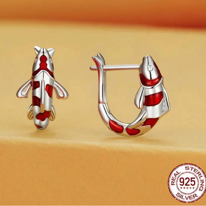 Guardian lucky fish huggie hoop earrings in 925 sterling silver with red enamel detailing, symbolic animal design on a beige backdrop — OmniVivo