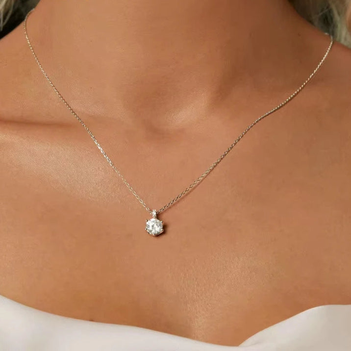Model wearing 1ct D color VVS1 moissanite solitaire pendant on a 925 sterling silver O-chain