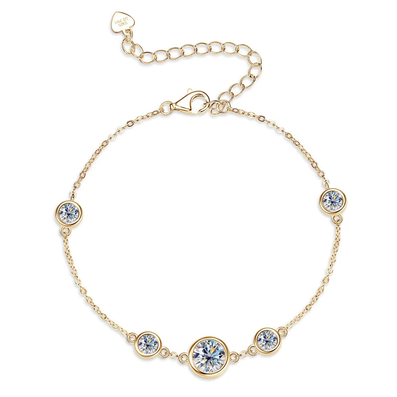 Gold-tone 925 sterling silver moissanite station bracelet with 6.5 mm center and graduated bezel-set accents, adjustable extender chain with heart tag on a white background — OmniVivo