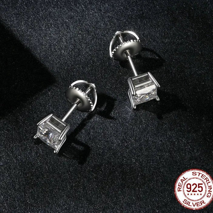 Close-up of screw-back basket setting for 0.5–1 ct D-Color VVS1 moissanite stud earrings in 925 sterling silver, white-gold finish, on a dark background — OmniVivo