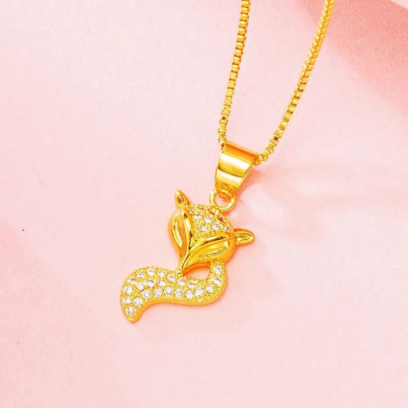 24K (9999) pure gold fox pendant necklace with zircon accents — close-up on pink background.