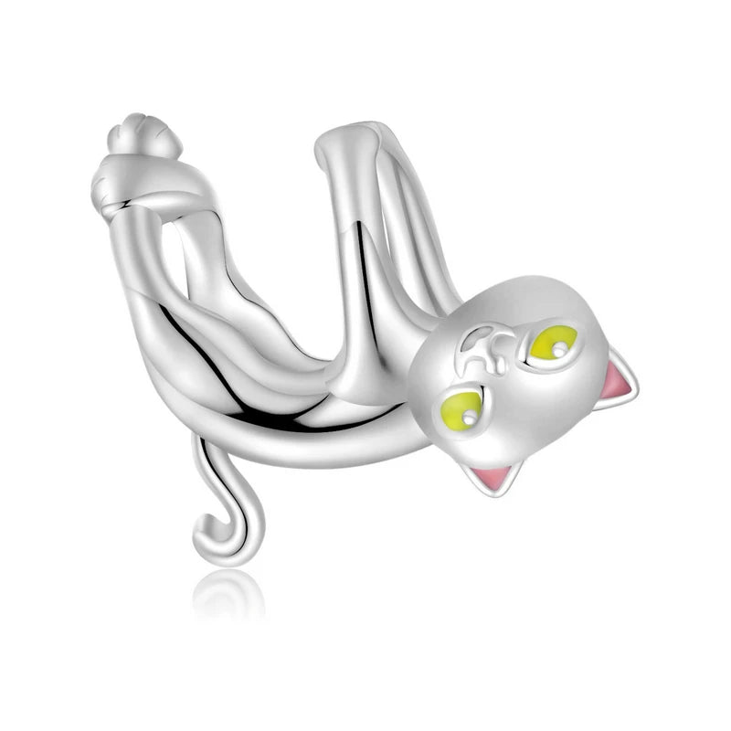 925 sterling silver cat charm bead with green enamel eyes and a pink nose, playful pose on a white background.