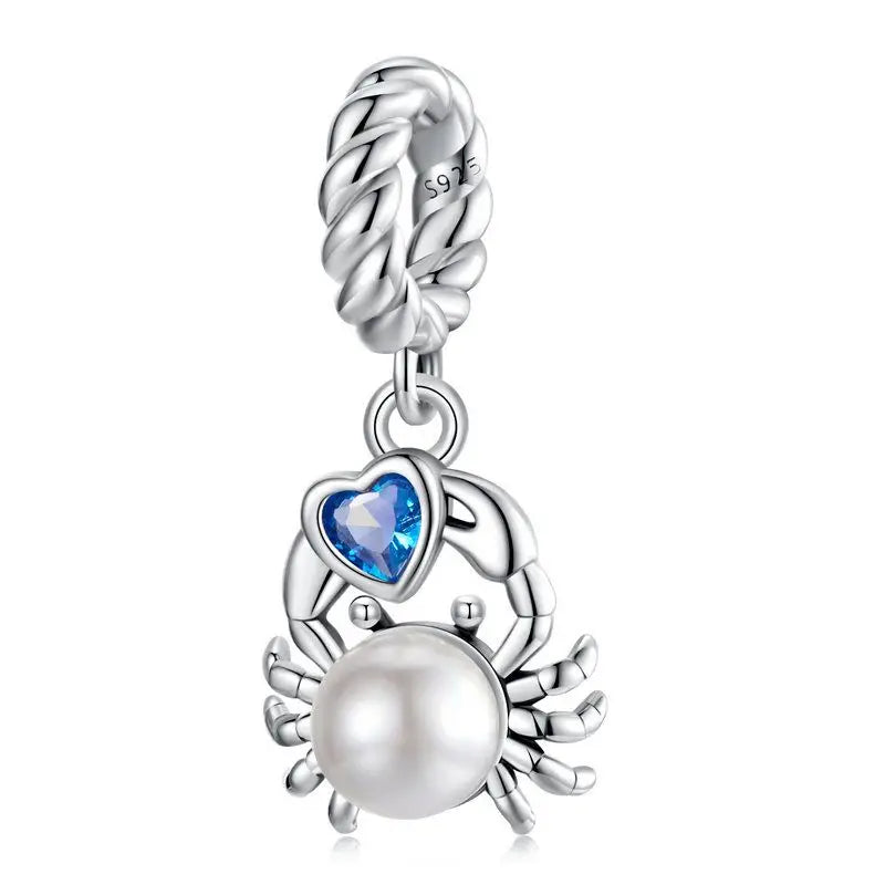 925 sterling silver crab charm bead with a round pearl and blue heart-shaped zircon on a white background.