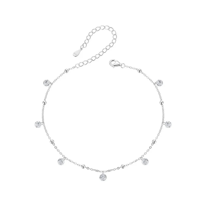 925 sterling silver cubic zirconia anklet with adjustable extender and dangle charms — circle flatlay on white background.