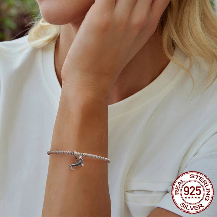 925 silver bracelet with dachshund dog charm bead worn on wrist.