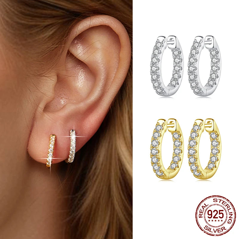 Moissanite hoop earrings in 925 sterling silver and gold-plated, worn on ear — D color VVS1, close-up.