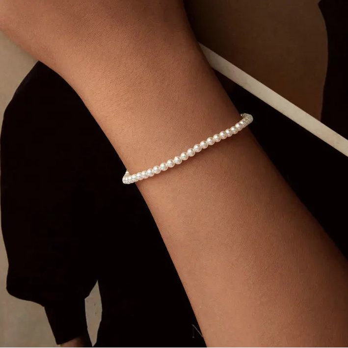 Shell pearl bracelet worn on a wrist, crafted in 925 sterling silver with adjustable fit — OmniVivo
